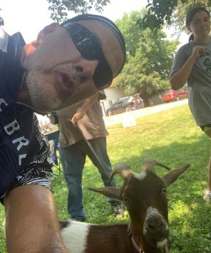 man with goat smiling